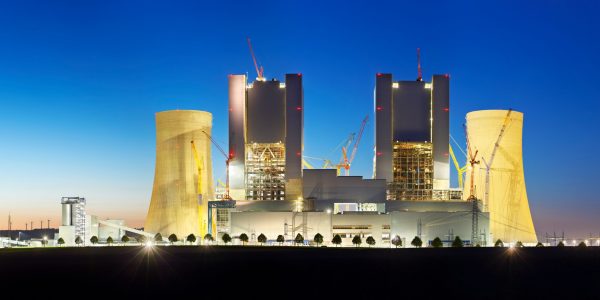 Panoramic view of a construction site of a new brown coal power plant at night.
